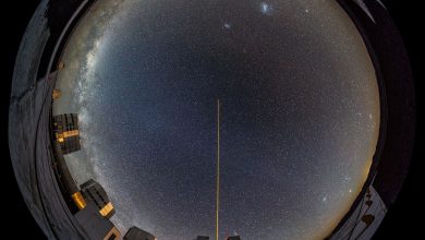 telescope pointed at a star-filled night sky