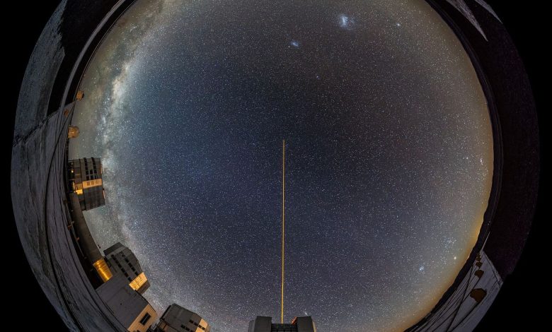 telescope pointed at a star-filled night sky