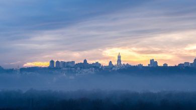 The Kyiv skyline at dawn above a layer of mist