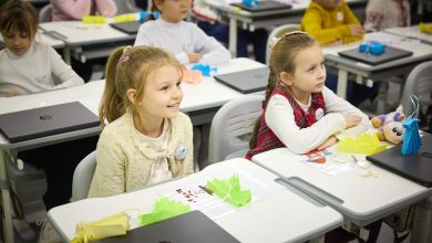 Students raising hands in a lesson at a school with a phone ban