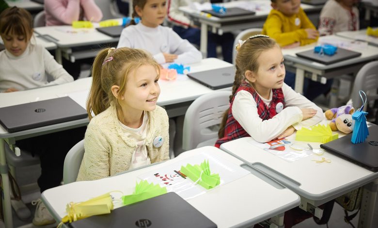 Students raising hands in a lesson at a school with a phone ban