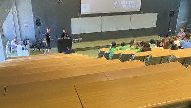 Students listening to a presentation inside a university lecture hall