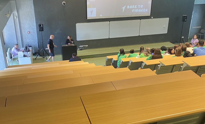 Students listening to a presentation inside a university lecture hall