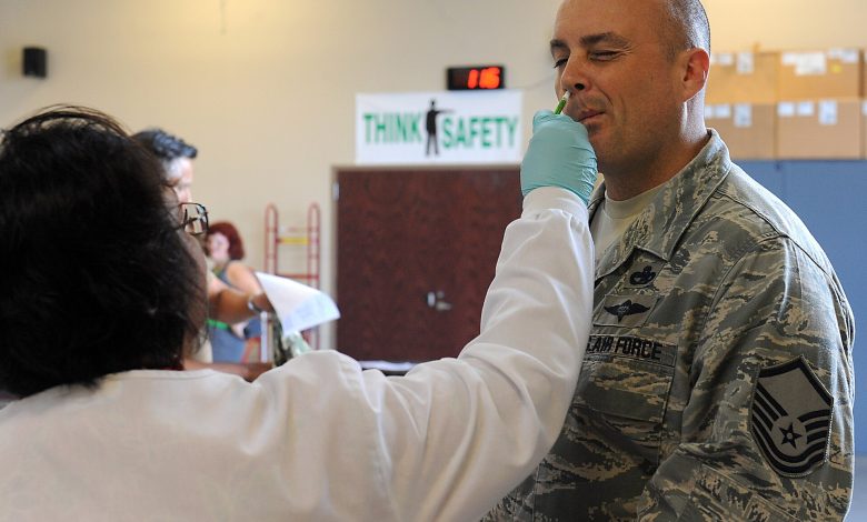 A public health worker preparing vaccination records at a clinic